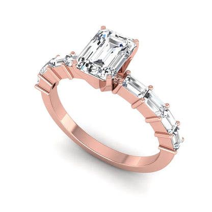Emerald cut lab grown diamond engagement ring with baguette side diamonds in a four-prong solitaire accent setting and rose gold tone band.