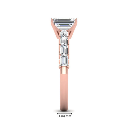 Emerald cut lab grown diamond engagement ring with baguette side diamonds in a four-prong solitaire accent setting and rose gold tone band.