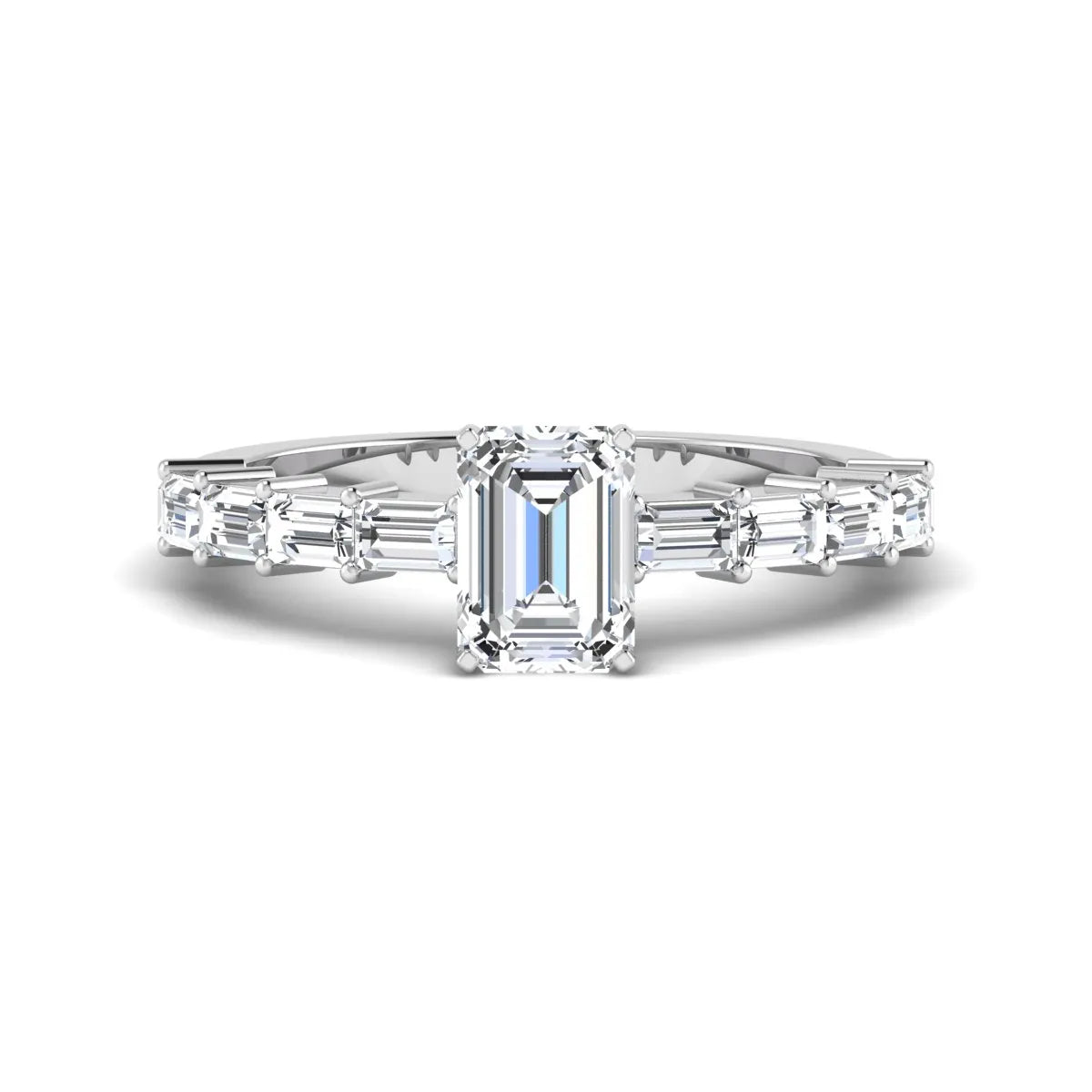Emerald cut lab grown diamond engagement ring with baguette side diamonds in a four-prong solitaire accent setting and white gold tone band.