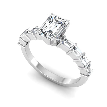 Emerald cut lab grown diamond engagement ring with baguette side diamonds in a four-prong solitaire accent setting and white gold tone band.