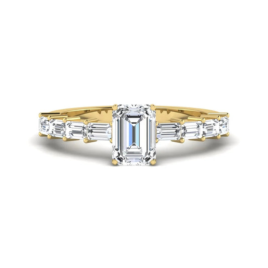 Emerald cut lab grown diamond engagement ring with baguette side diamonds in a four-prong solitaire accent setting and yellow gold tone band.