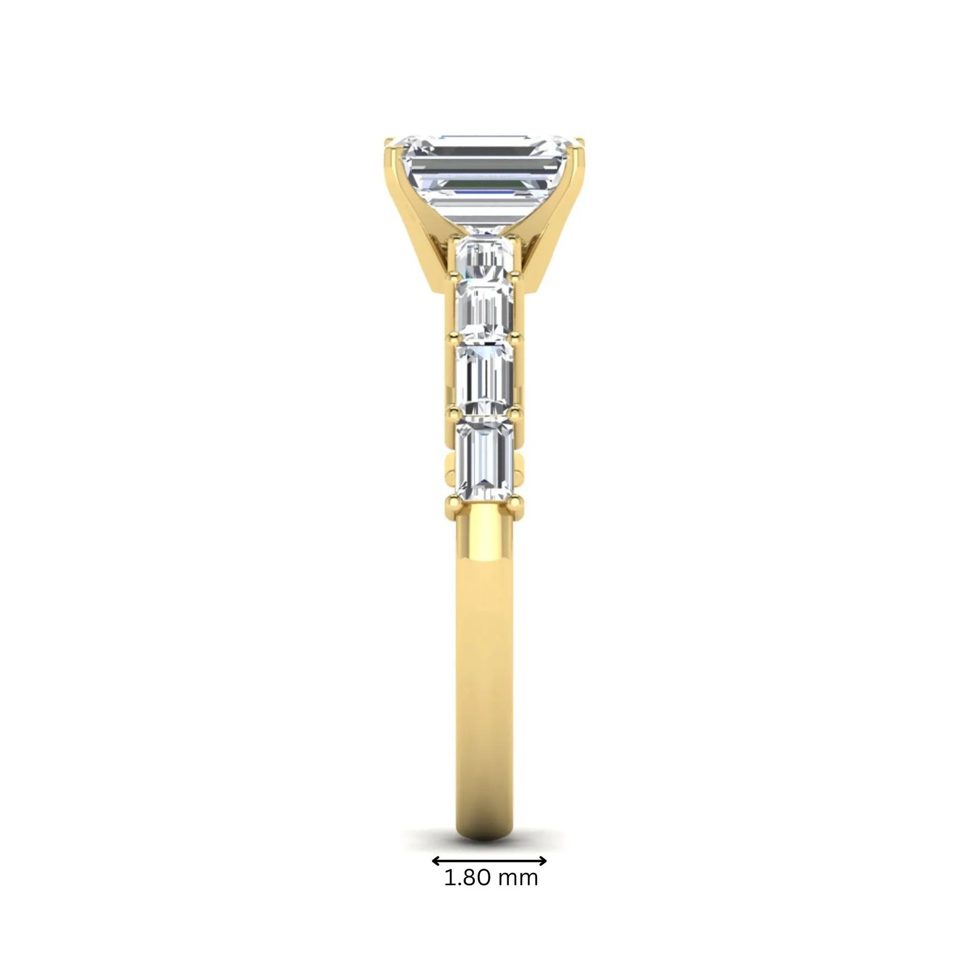 Emerald cut lab grown diamond engagement ring with baguette side diamonds in a four-prong solitaire accent setting and yellow gold tone band.