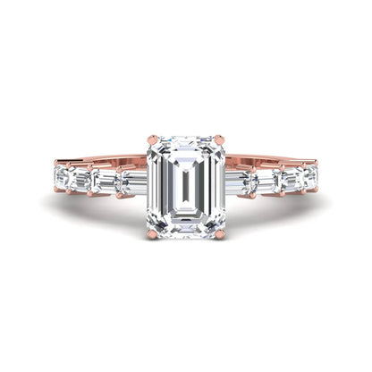 Emerald cut lab grown diamond engagement ring with baguette side diamonds in a four-prong solitaire accent setting and rose gold tone band.