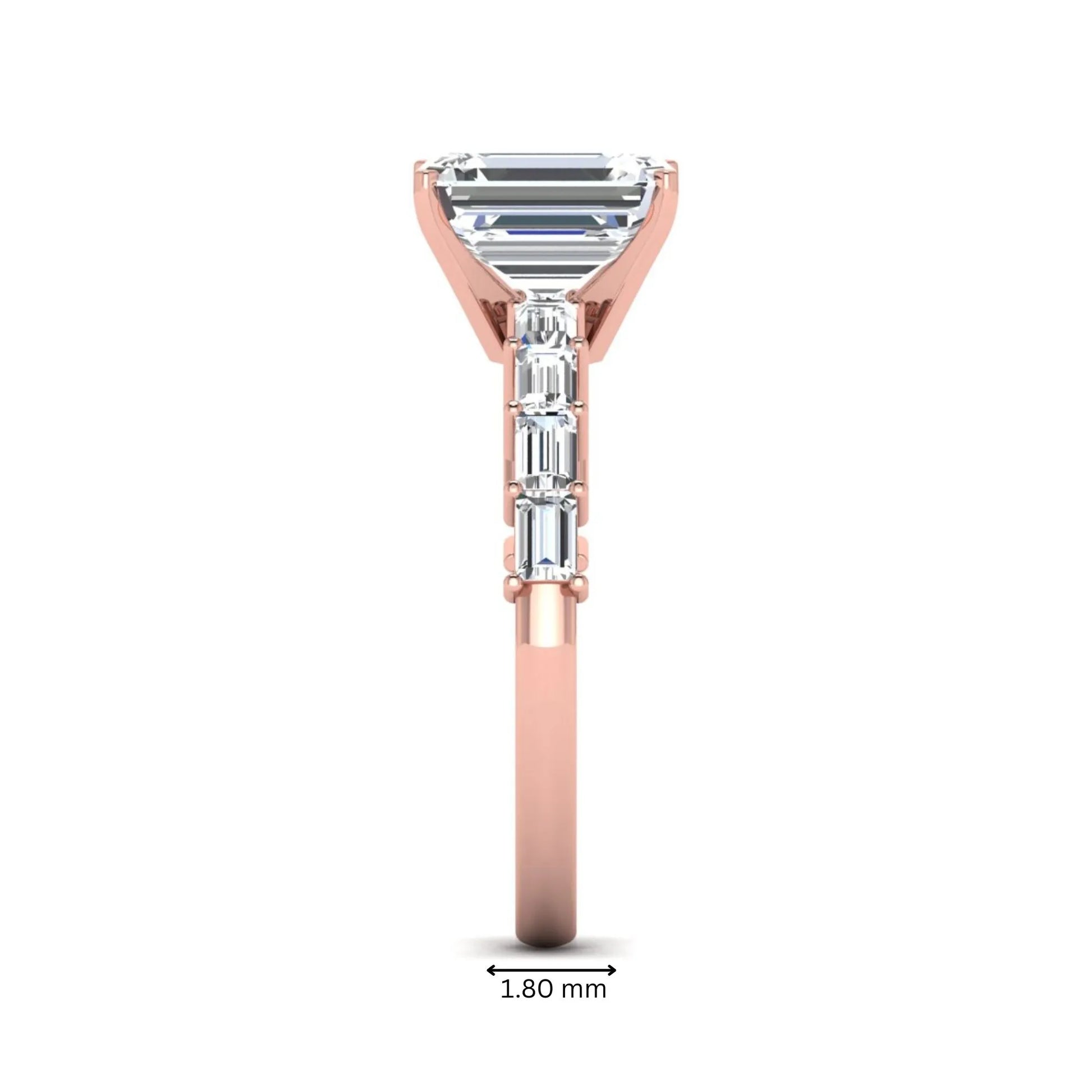 Emerald cut lab grown diamond engagement ring with baguette side diamonds in a four-prong solitaire accent setting and rose gold tone band.