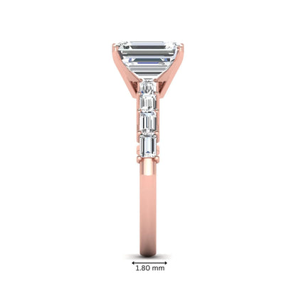 Emerald cut lab grown diamond engagement ring with baguette side diamonds in a four-prong solitaire accent setting and rose gold tone band.