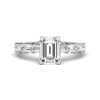 Emerald cut lab grown diamond engagement ring with baguette side diamonds in a four-prong solitaire accent setting and white gold tone band.