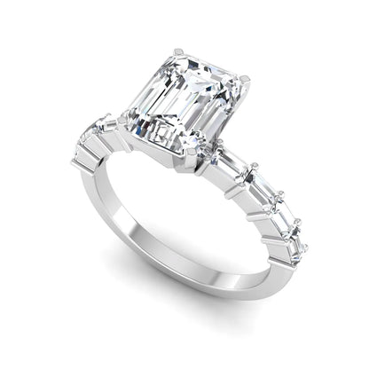 Emerald cut lab grown diamond engagement ring with baguette side diamonds in a four-prong solitaire accent setting and white gold tone band.