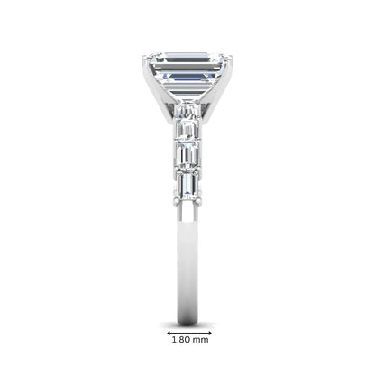 Emerald cut lab grown diamond engagement ring with baguette side diamonds in a four-prong solitaire accent setting and white gold tone band.
