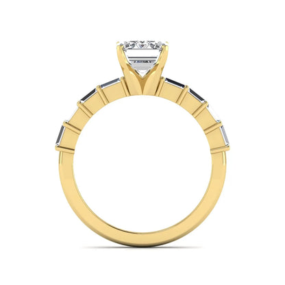 Emerald cut lab grown diamond engagement ring with baguette side diamonds in a four-prong solitaire accent setting and yellow gold tone band.