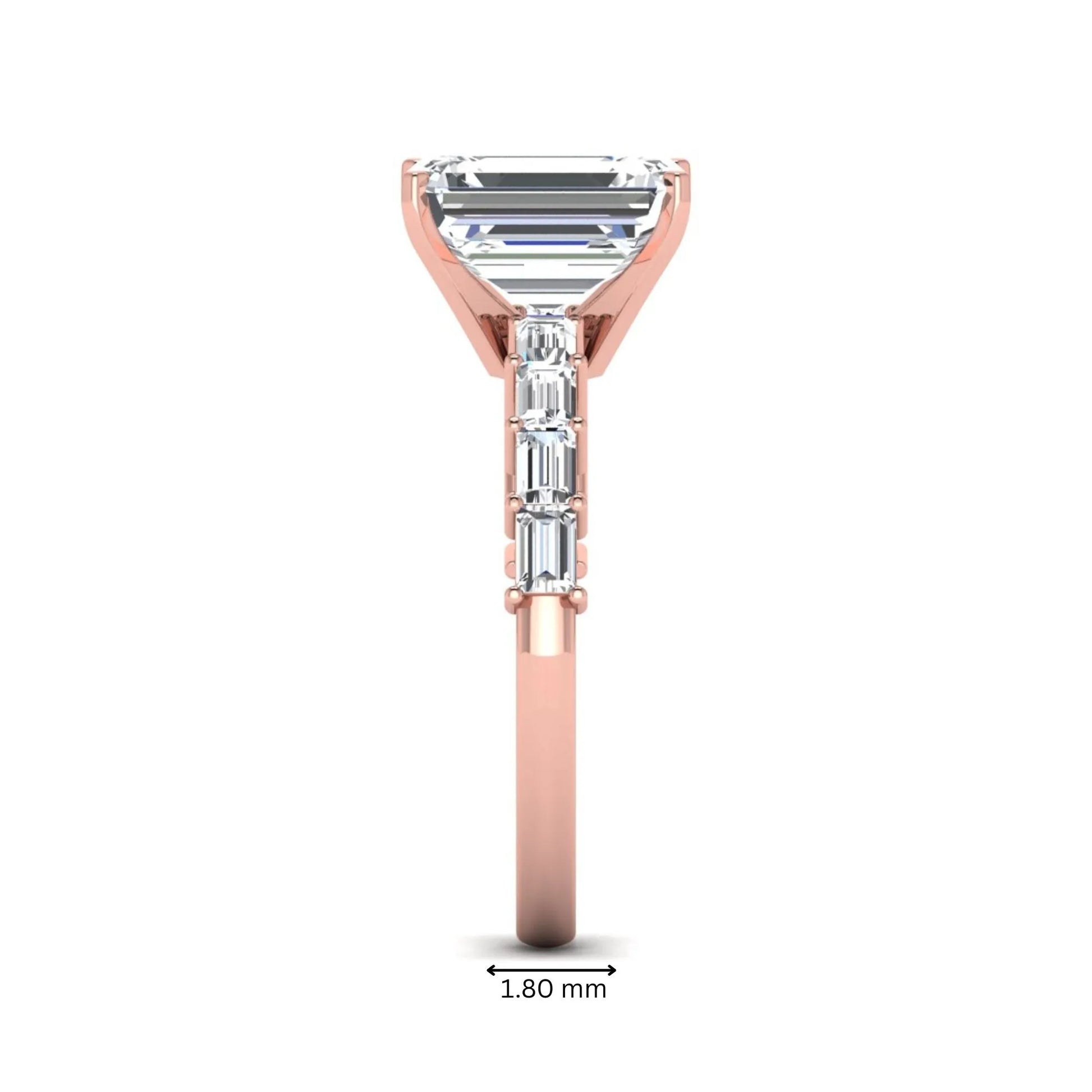 Emerald cut lab grown diamond engagement ring with baguette side diamonds in a four-prong solitaire accent setting and rose gold tone band.