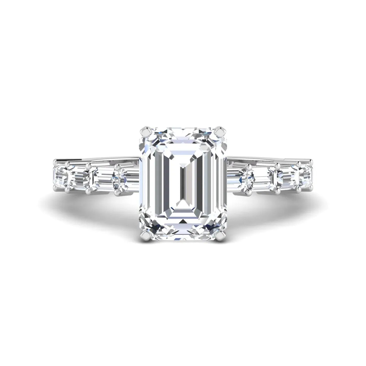 Emerald cut lab grown diamond engagement ring with baguette side diamonds in a four-prong solitaire accent setting and white gold tone band.