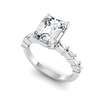 Emerald cut lab grown diamond engagement ring with baguette side diamonds in a four-prong solitaire accent setting and white gold tone band.