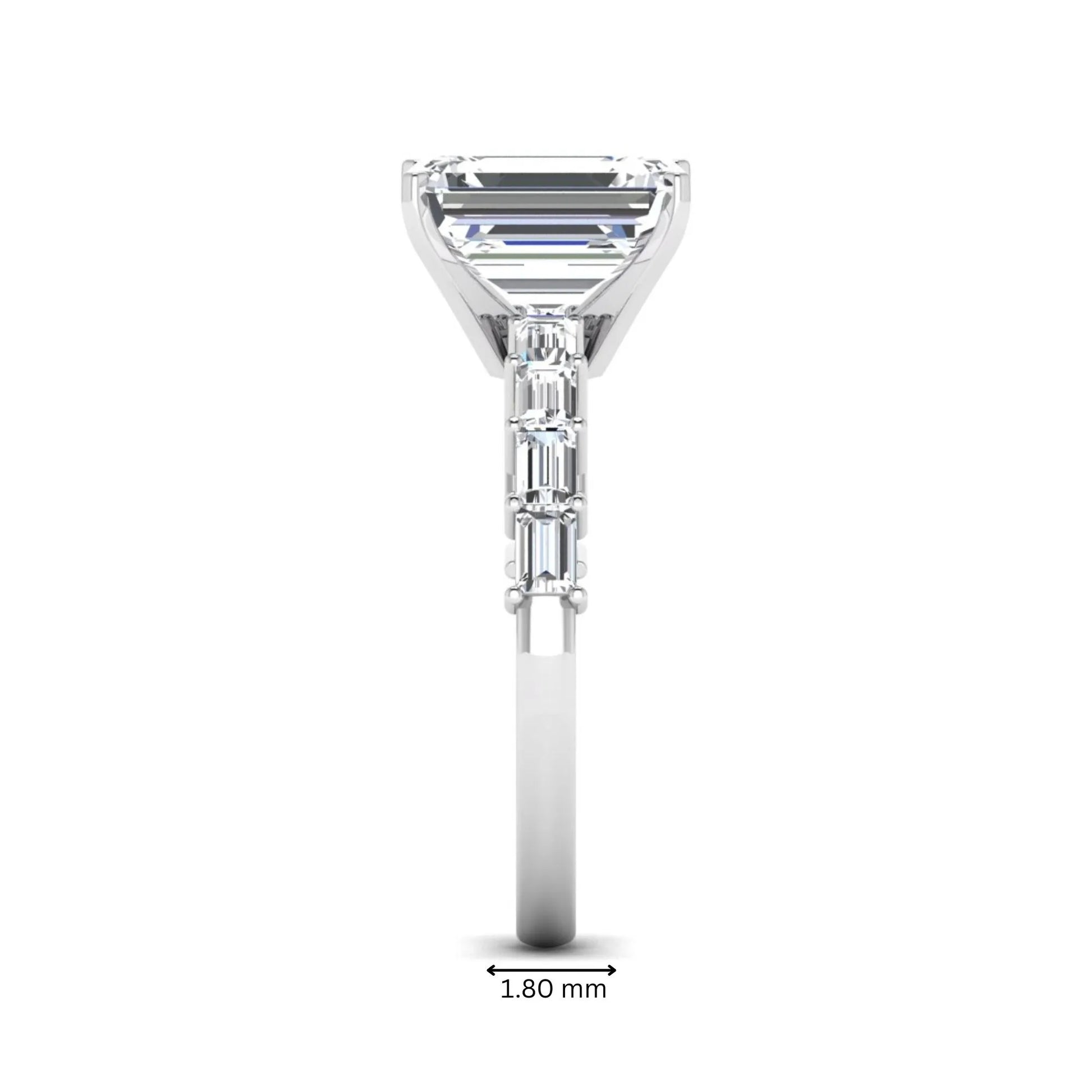 Emerald cut lab grown diamond engagement ring with baguette side diamonds in a four-prong solitaire accent setting and white gold tone band.