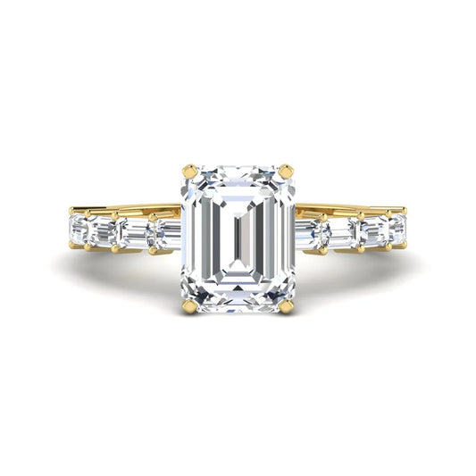Emerald cut lab grown diamond engagement ring with baguette side diamonds in a four-prong solitaire accent setting and yellow gold tone band.