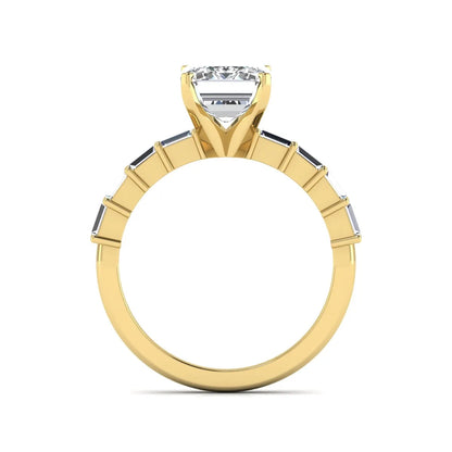 Emerald cut lab grown diamond engagement ring with baguette side diamonds in a four-prong solitaire accent setting and yellow gold tone band.