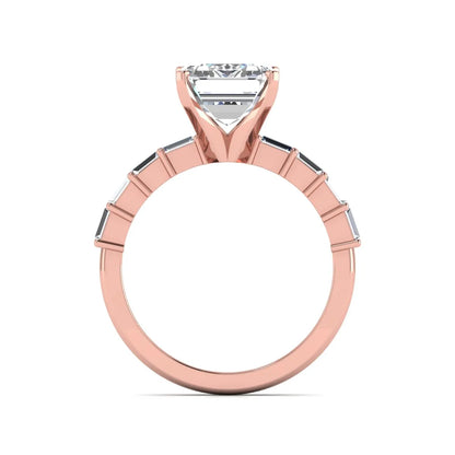 Emerald cut lab grown diamond engagement ring with baguette side diamonds in a four-prong solitaire accent setting and rose gold tone band.