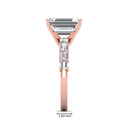 Emerald cut lab grown diamond engagement ring with baguette side diamonds in a four-prong solitaire accent setting and rose gold tone band.