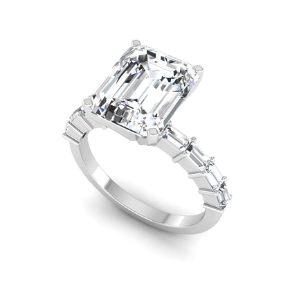 Emerald cut lab grown diamond engagement ring with baguette side diamonds in a four-prong solitaire accent setting and white gold tone band.