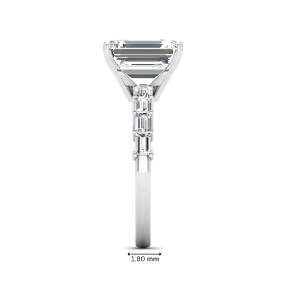 Emerald cut lab grown diamond engagement ring with baguette side diamonds in a four-prong solitaire accent setting and white gold tone band.