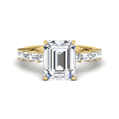 Emerald cut lab grown diamond engagement ring with baguette side diamonds in a four-prong solitaire accent setting and yellow gold tone band.