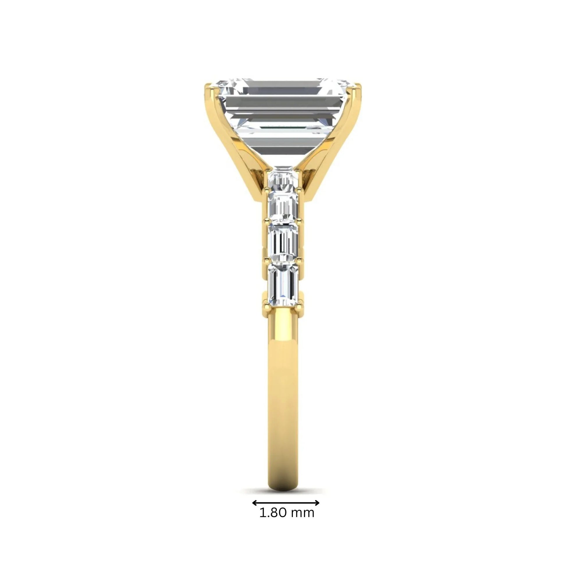 Emerald cut lab grown diamond engagement ring with baguette side diamonds in a four-prong solitaire accent setting and yellow gold tone band.