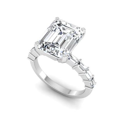 Emerald cut lab grown diamond engagement ring with baguette side diamonds in a four-prong solitaire accent setting and white gold tone band.