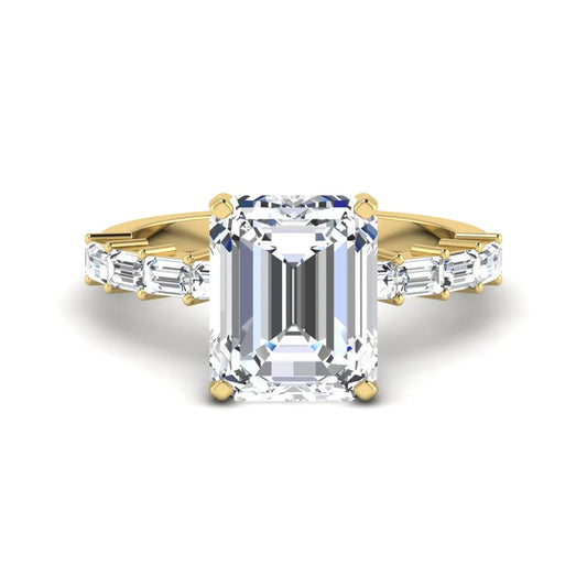 Emerald cut lab grown diamond engagement ring with baguette side diamonds in a four-prong solitaire accent setting and yellow gold tone band.