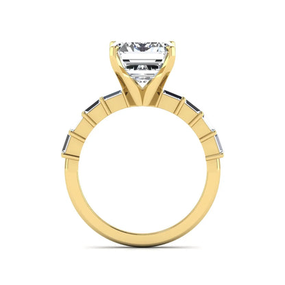 Emerald cut lab grown diamond engagement ring with baguette side diamonds in a four-prong solitaire accent setting and yellow gold tone band.