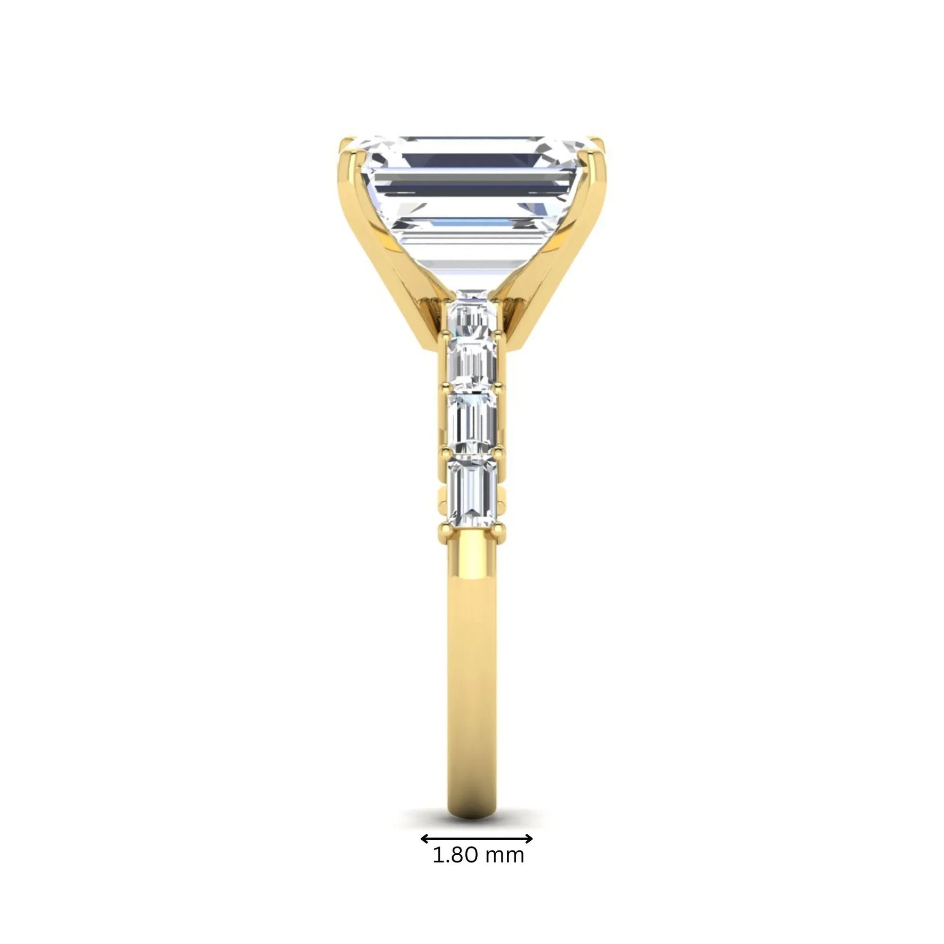 Emerald cut lab grown diamond engagement ring with baguette side diamonds in a four-prong solitaire accent setting and yellow gold tone band.
