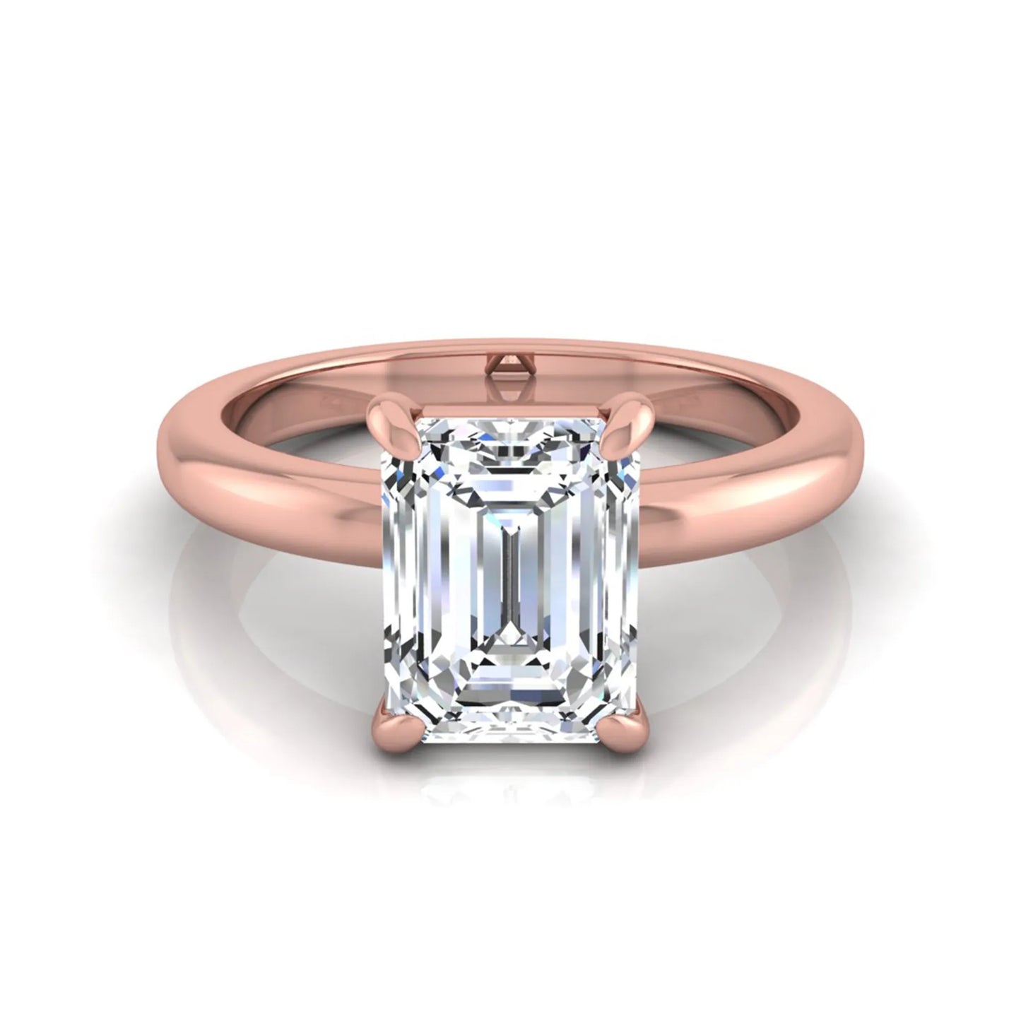 Emerald cut lab grown diamond solitaire engagement ring featuring an IGI certified center diamond in a classic four-prong setting with a polished band in rose gold