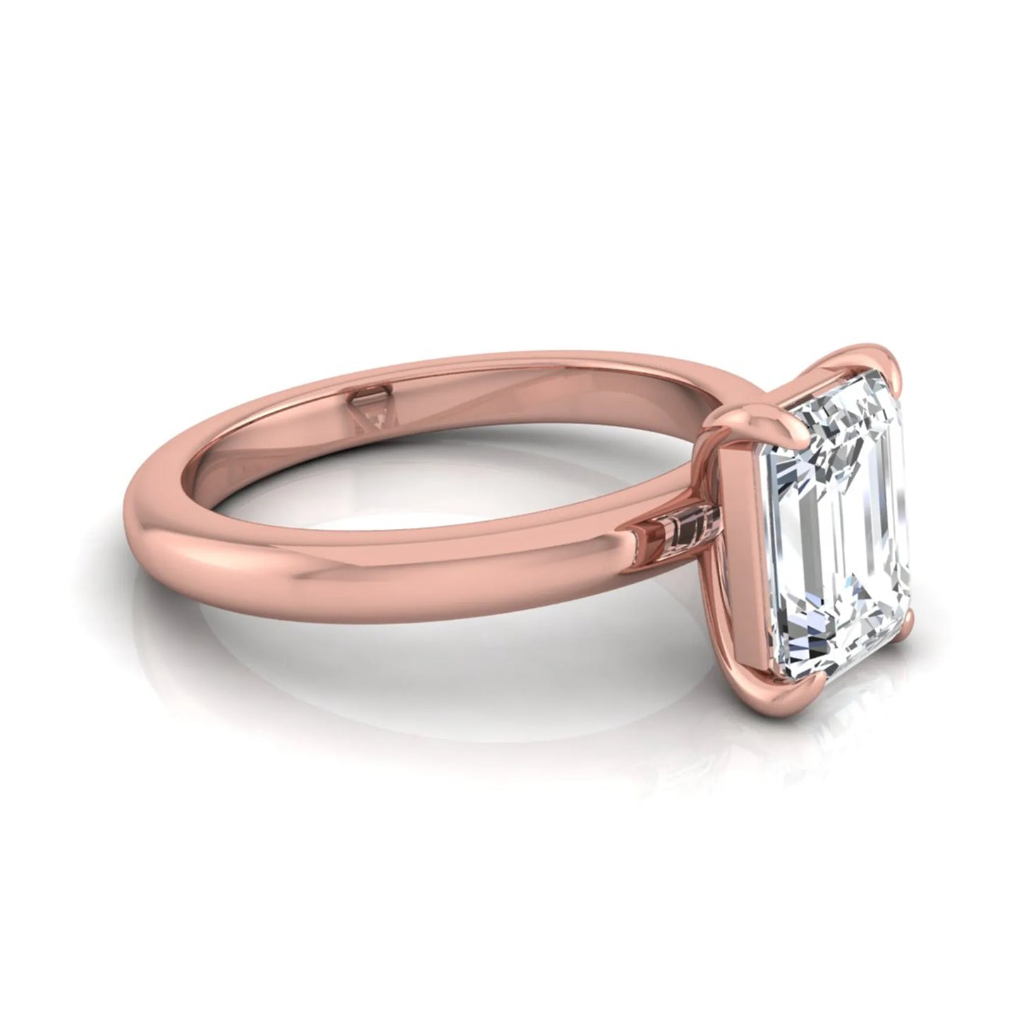Emerald cut lab grown diamond solitaire engagement ring featuring an IGI certified center diamond in a classic four-prong setting with a polished band in rose gold