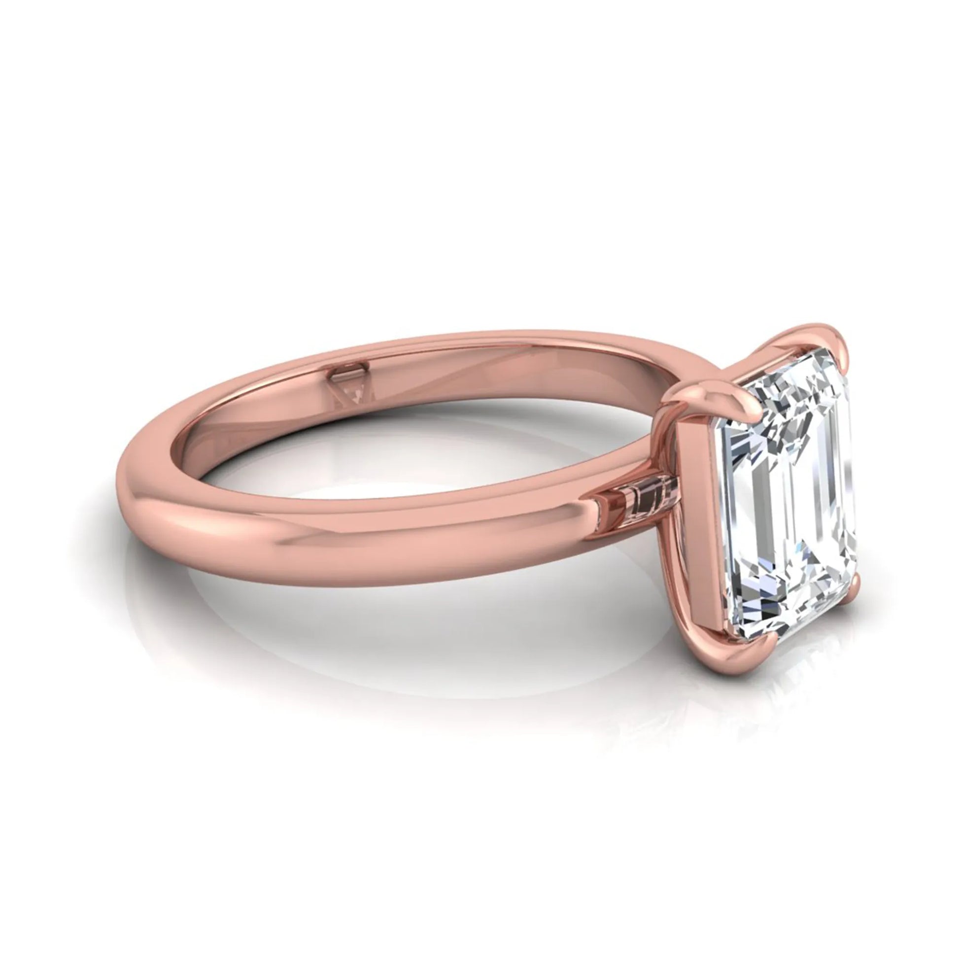 Emerald cut lab grown diamond solitaire engagement ring featuring an IGI certified center diamond in a classic four-prong setting with a polished band in rose gold
