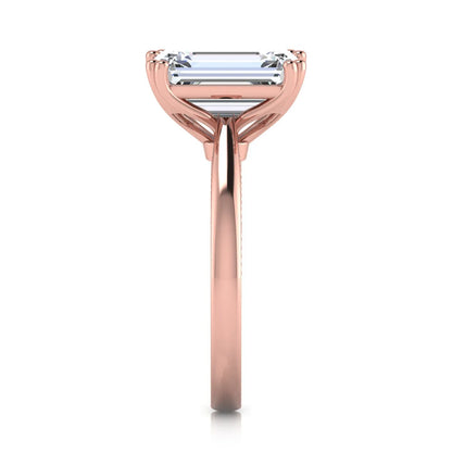 Emerald cut lab grown diamond engagement ring featuring a 3.01 carat IGI certified center diamond in a four-prong solitaire setting with hidden round diamond accents beneath the gallery and a polished rose gold band.