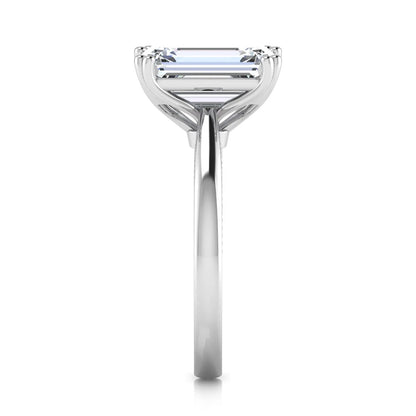 Emerald cut lab grown diamond engagement ring featuring a 3.01 carat IGI certified center diamond in a four-prong solitaire setting with hidden round diamond accents beneath the gallery and a polished white gold band.