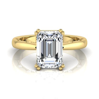 Emerald cut lab grown diamond engagement ring featuring a 3.01 carat IGI certified center diamond in a four-prong solitaire setting with hidden round diamond accents beneath the gallery and a polished yellow gold band.