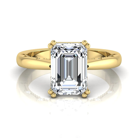 Emerald cut lab grown diamond engagement ring featuring a 3.01 carat IGI certified center diamond in a four-prong solitaire setting with hidden round diamond accents beneath the gallery and a polished yellow gold band.