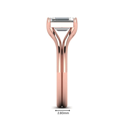 IGI certified 1.75 carat emerald cut lab grown diamond solitaire engagement ring with elegant split shank in rose gold.