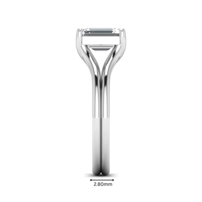 IGI certified 1.75 carat emerald cut lab grown diamond solitaire engagement ring with elegant split shank in white gold.