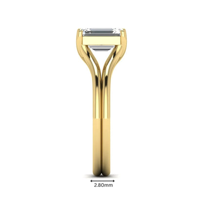 IGI certified 1.75 carat emerald cut lab grown diamond solitaire engagement ring with elegant split shank in yellow gold.