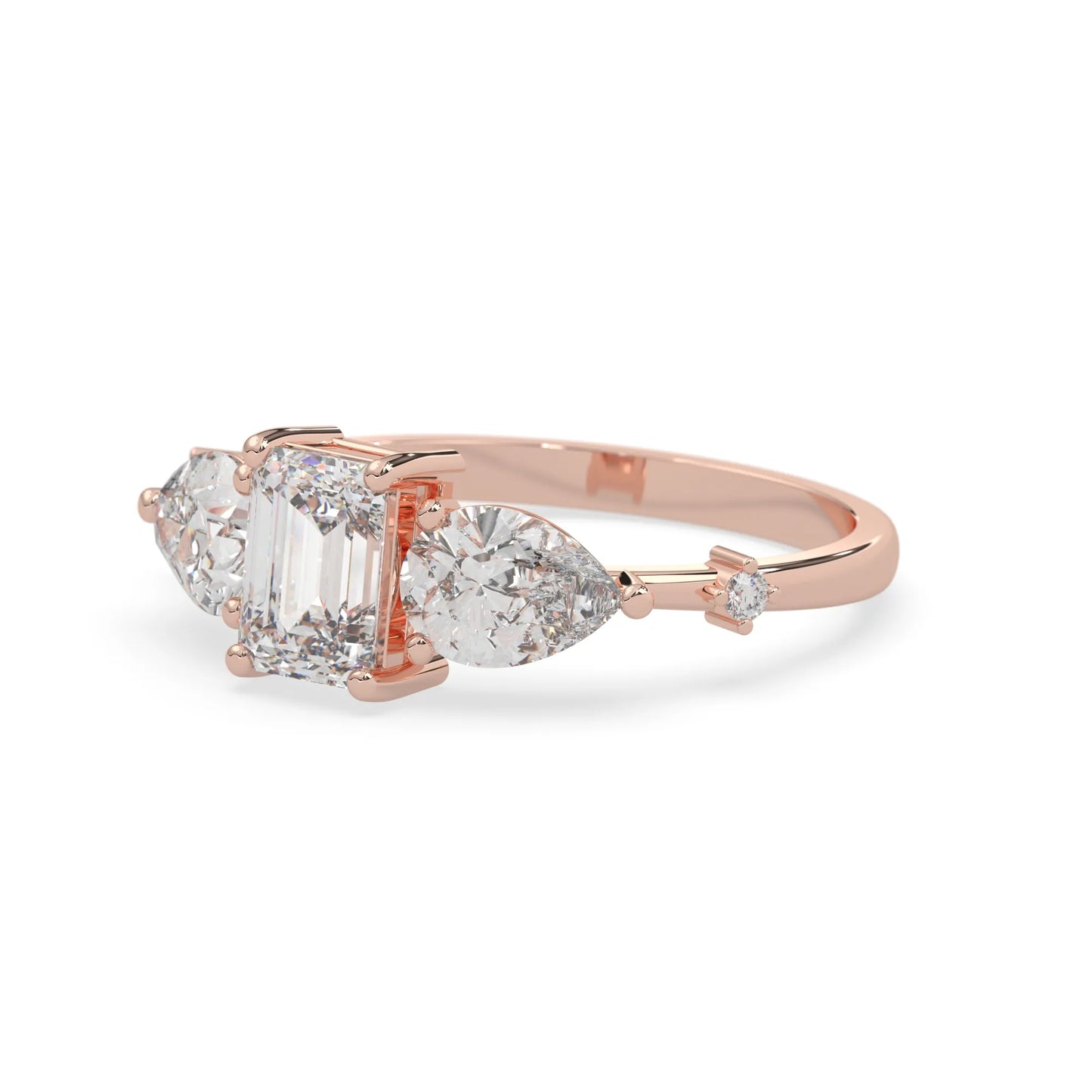 Emerald cut lab grown diamond engagement ring with pear and round diamond three stone design in rose gold