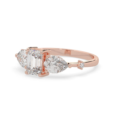 Emerald cut lab grown diamond engagement ring with pear and round diamond three stone design in rose gold