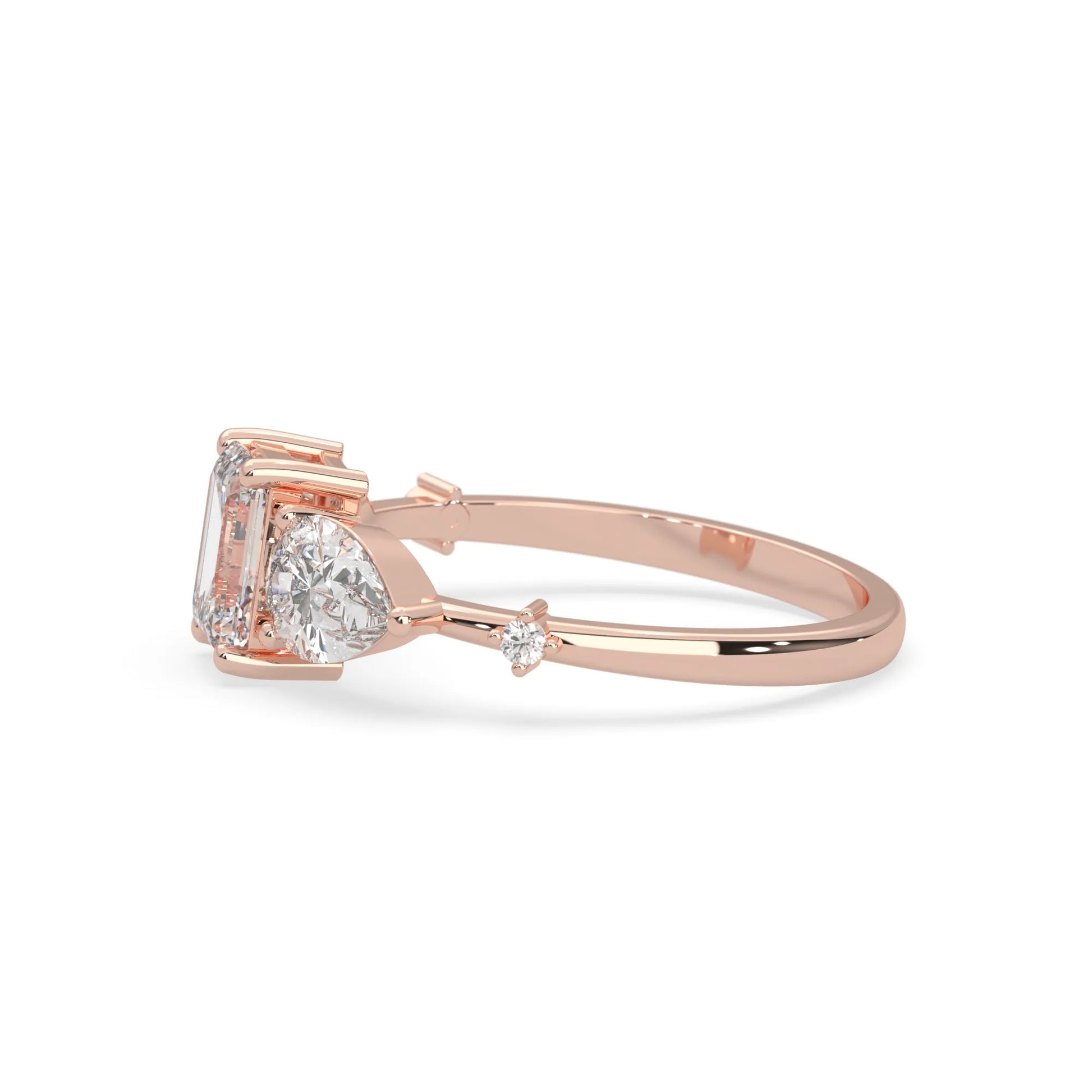 Emerald cut lab grown diamond engagement ring with pear and round diamond three stone design in rose gold