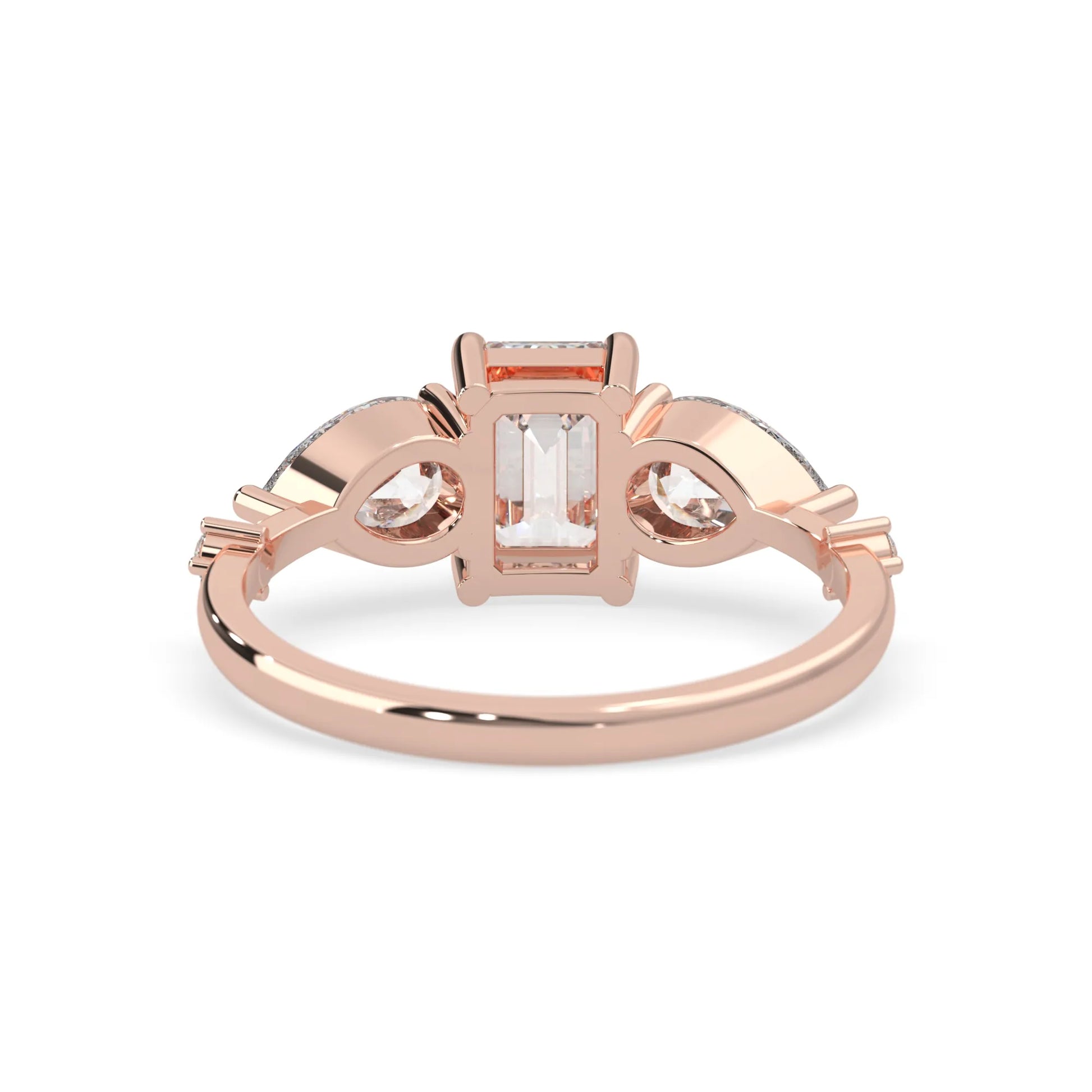 Emerald cut lab grown diamond engagement ring with pear and round diamond three stone design in rose gold