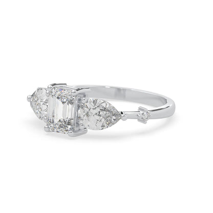 Emerald cut lab grown diamond engagement ring with pear and round diamond three stone design in white gold