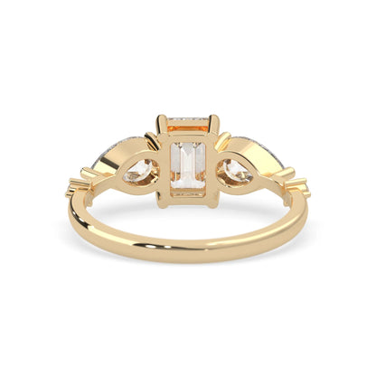 Emerald cut lab grown diamond engagement ring with pear and round diamond three stone design in yellow gold
