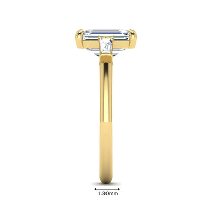 IGI Certified 2.20 carat emerald cut lab grown diamond engagement ring with tapered baguette side diamonds in yellow gold.