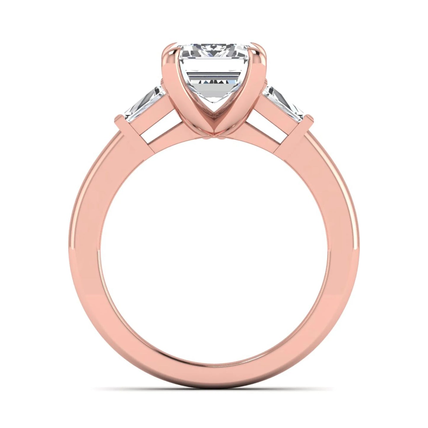 Emerald cut lab grown diamond three-stone engagement ring featuring tapered baguette side diamonds in a classic four-prong rose gold style setting.