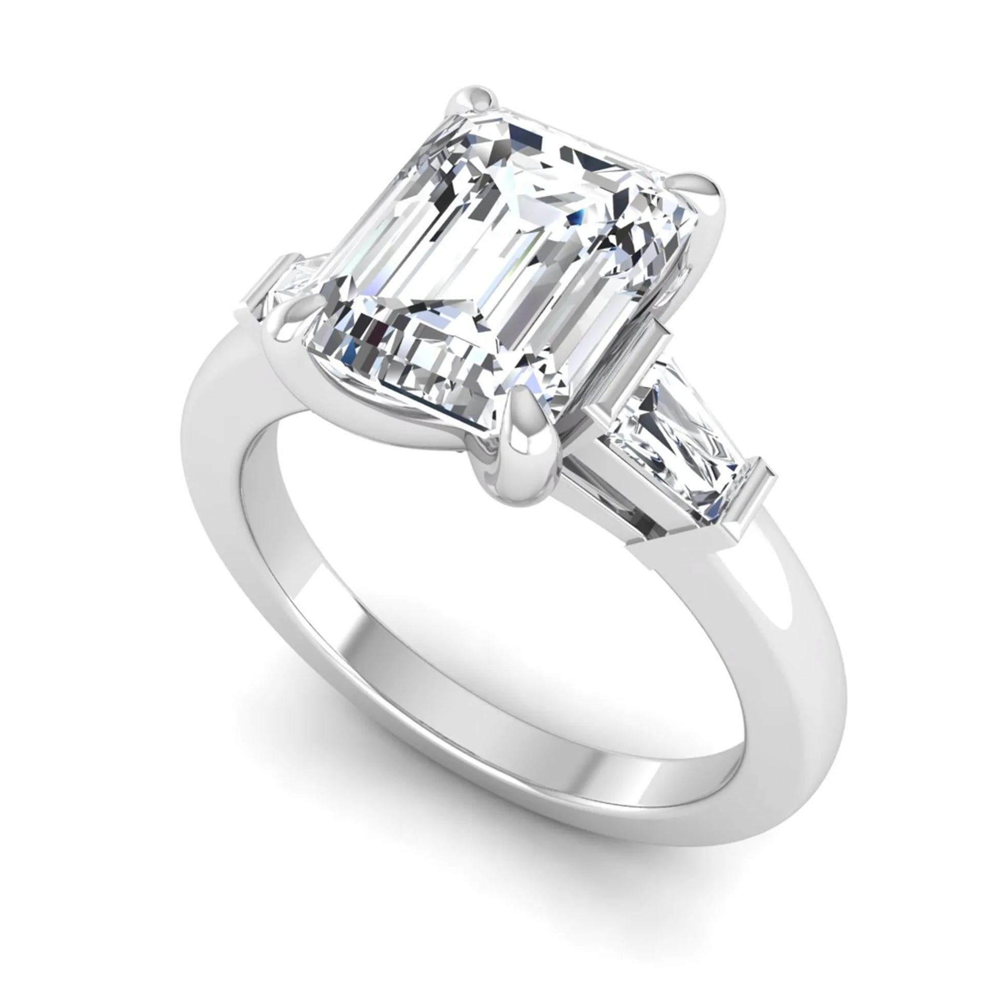 Emerald cut lab grown diamond three-stone engagement ring featuring tapered baguette side diamonds in a classic four-prong white gold style setting.