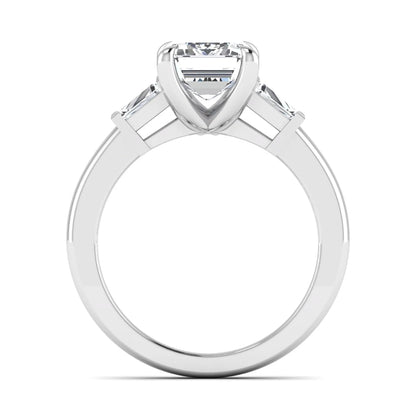 Emerald cut lab grown diamond three-stone engagement ring featuring tapered baguette side diamonds in a classic four-prong white gold style setting.