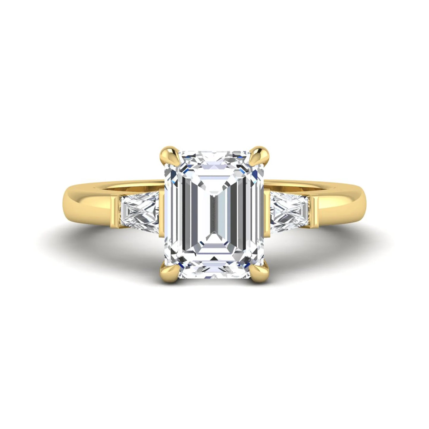 Emerald cut lab grown diamond three-stone engagement ring featuring tapered baguette side diamonds in a classic four-prong yellow gold style setting.